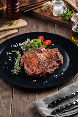 Juicy beef steak on a black plate