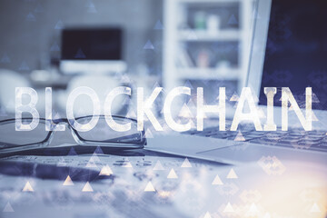 Crypto theme hologram with glasses on the table background. Concept of blockchain. Double exposure.