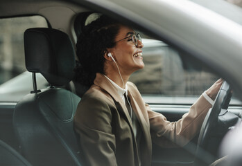 Businesswoman enjoying music while driving to work