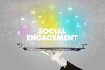 Waiter serving social networking with SOCIAL ENGAGEMENT inscription, new media concept