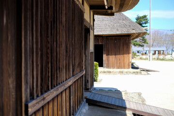 Wall texture of traditional Japanese Houses at Hitachi Seaside Park.,old Miharashi Village surrounding of blue nemophila flower field flowers in spring time.House demonstrate cooking ware inside.