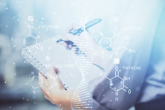 DNA theme hologram over woman's hands writing background. Concept of education. Double exposure