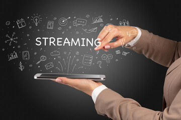Obraz premium Close-up of a touchscreen with STREAMING inscription, social media concept