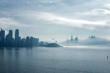 The beautiful beach and bay with thick mist blow from the sea to the land.
