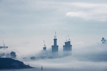 The beautiful beach and bay with thick mist blow from the sea to the land.