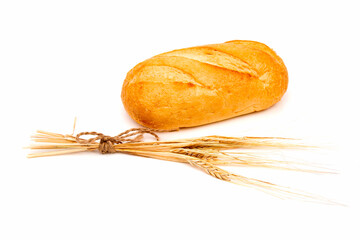 Loaf of rye bread or baguette with ear of wheat on white background.