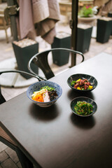 Dark table served with asian style japanese dishes