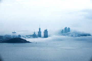 The   beach and bay with thick large mist blow from the sea to the land.