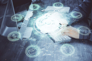 Social network theme hologram with businessman working on computer on background. Concept of world...