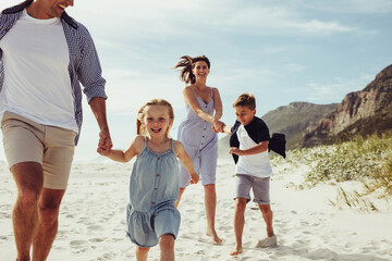 Kids having fun with parents on beach vacation