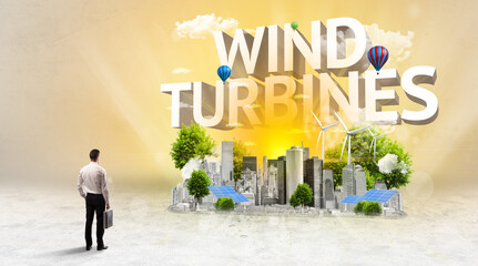 Rear view of a businessman standing in front of WIND TURBINES inscription, Environmental protection concept