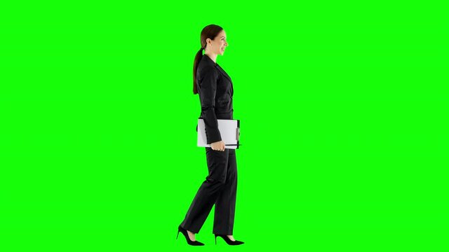 Happy Office Woman Wearing an Elegant Suit Walking With a Clipboard Green Screen