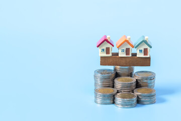 Mini house on stack of coins,Money and house,  Mortgage, Savings money for buy house and loan to...