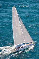Racing yacht Caro sails out of the Sydney Heads at the start of the 2014 Sydney to Hobart Yacht Race - obrazy, fototapety, plakaty