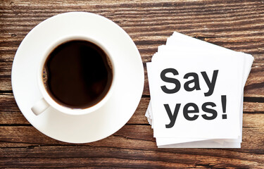 Word writing text Say yes . Business concept for Urgent Move.Text in stickers with a cap of coffee