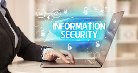 INFORMATION SECURITY inscription on laptop, internet security and data protection concept, blockchain and cybersecurity