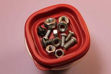 screws and bolts top view on a plastic box