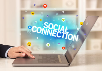 Freelance woman using laptop with SOCIAL CONNECTION inscription, Social media concept