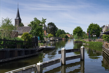 View from the drawbridge of the village of Heeg in Friesland, the Netherlands with the Saint Joseph's Church