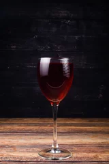 Fotobehang glass of red wine on wooden background © Aleksander Savelev