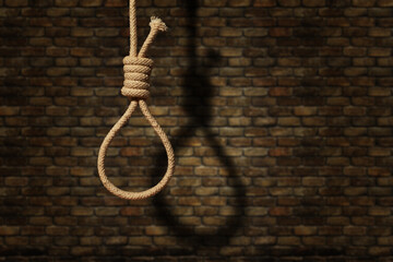 suicide concept. noose with shadow on dark wall background