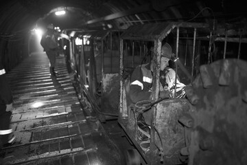 Silhouette of a working miner in a mine