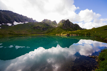Naklejka na ściany i meble Alpine mountain lake landscape and view, blue beautiful and amazing lake panorama