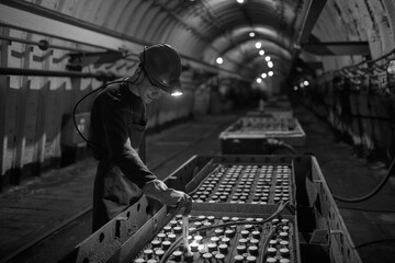 Silhouette of a working miner in a mine