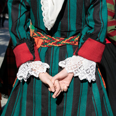 Details of Bulgarian traditional folk costume on young girl dancer from Trakia ensemble. Elements of national folk dress with embroidered patterns.