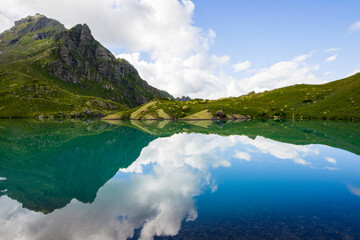 Fototapeta na wymiar Alpine mountain lake landscape and view, blue beautiful and amazing lake panorama
