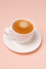 coffee in a cup on a pink background.