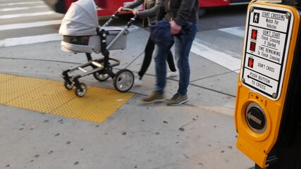 Traffic light button on pedestrian crosswalk, people have to push and wait. Traffic rules and regulations for public safety in USA. Zebra street crossing on road intesection in San Diego, California