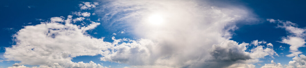 White fluffy cumulus clouds in deep blue azure sunshine sky. Summer good weather, climate, eco, nature beauty concept sky ultra wide high resolution panoramic background.