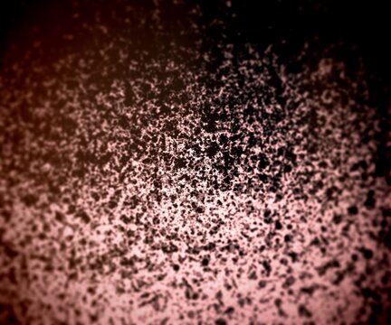 Dirty black dots texture with circular blur. Dark background with selective focus.