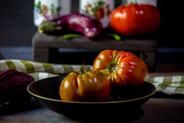 Preparation with vegetables on dark ground in the kitchen