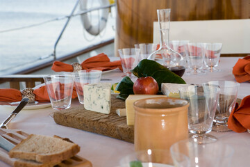 Fototapeta na wymiar Deck of a classic wooden sailing yacht. Netherlands. Dinner table laid.