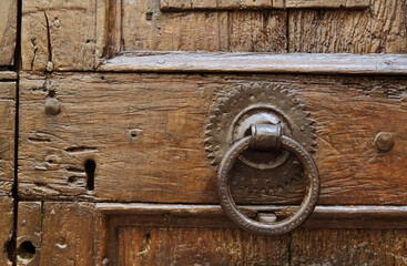 Detail of ancient door of a house in the medieval center of San Gimignano