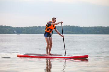 A young man on a sup board