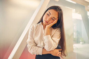 Fototapeta premium Bored longhaired female person touching her head