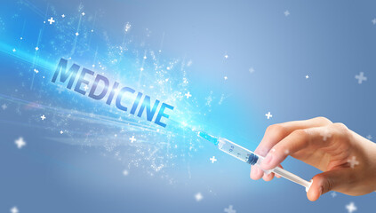 Syringe, medical injection in hand with MEDICINE inscription, medical antidote concept