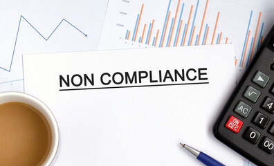 NON COMPLIANCE document with graphs, diagrams and calculator and a cup of fragrant coffee