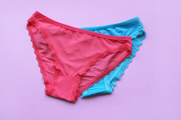 Set of women's panties on a pink background. Pink and blue underwear.