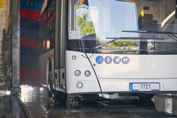 Close up of white bus being at washing