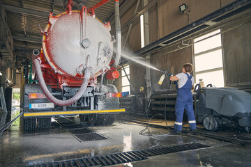 Silhouette of female person working at car wash