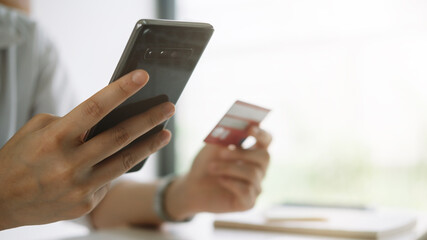 Shopping online with smartphone and credit card on hand