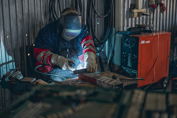 Concentrated welder using mask while doing serious work