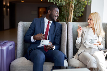 diverse business man and woman have nice talk in restaurant, after meeting. young people spend good...