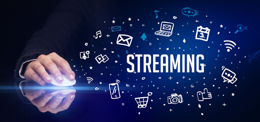 hand holding wireless peripheral with STREAMING inscription, social media concept