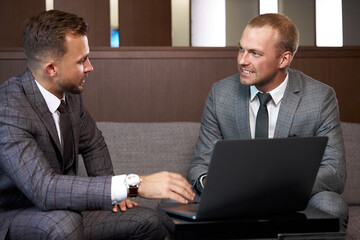 business men co-working with laptop, two guys have successful cooperation, have talk, discuss business ideas