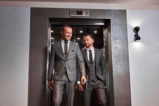 businessmen leave the elevator, two caucasian men after co-working. business people concept